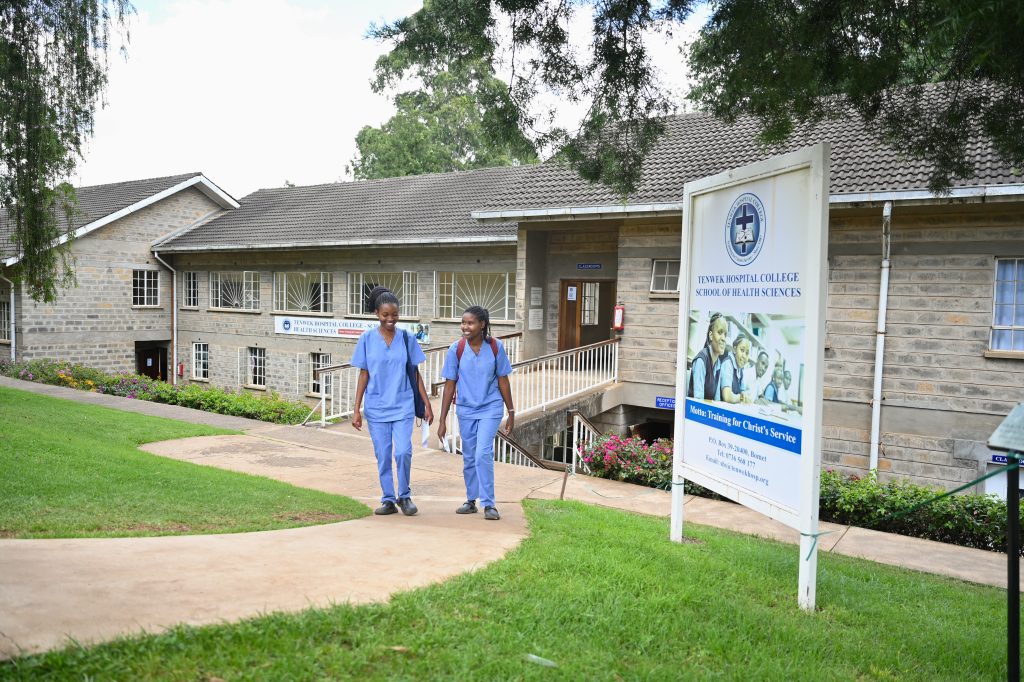 Students in uniform walking on the College of Health Sciences campus at Tenwek