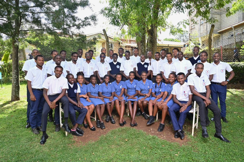 A class of students in uniform gathered for a group photo on campus